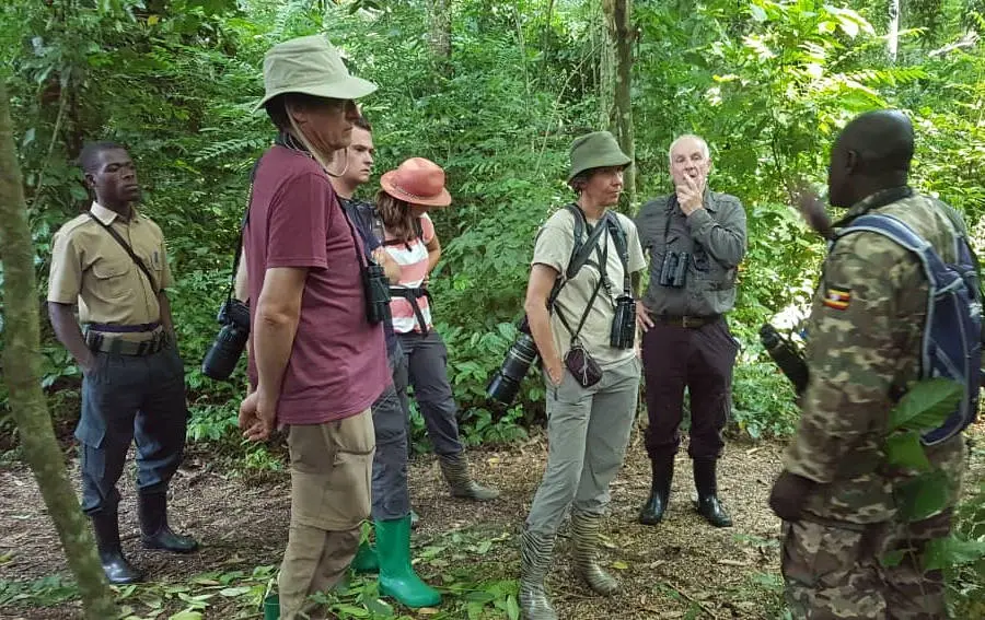 Tourists and guide preparing for forest trek** in **Semuliki National Park** on **Uganda safaris